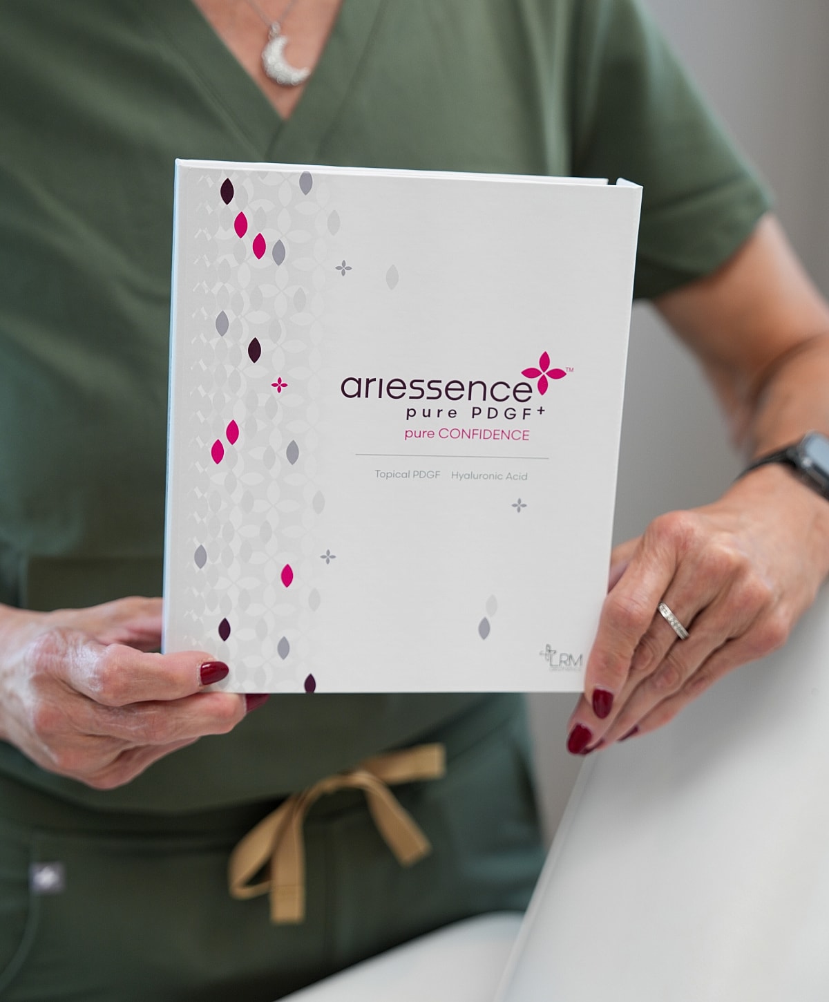 Ariessence PDGF product held by a person