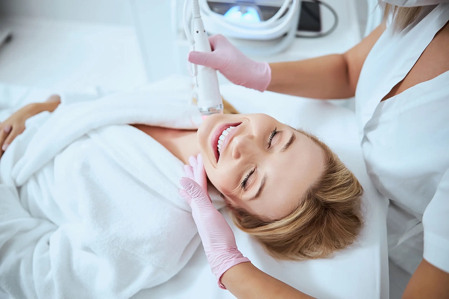 a woman lying down getting RF microneedling with Infini in Northborough MA